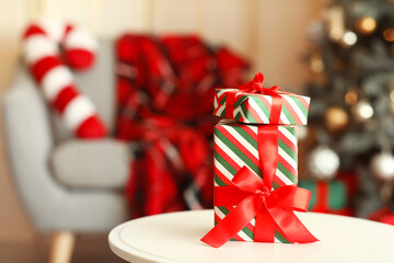 Christmas gift boxes on table in festive living room, closeup