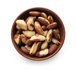 Bowl with tasty Brazil nuts on white background