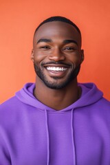 Poster - A person wearing a purple hoodie and smiling directly at the camera