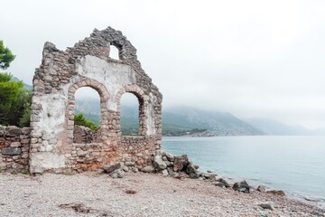 Aufkleber - A stone building sits atop a rugged rocky beach, perfect for coastal or architectural illustrations
