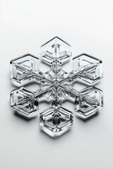 Poster - A detailed view of a delicate crystal snowflake sitting on a white background