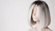 © Shabnam - Straight bob wig with an ombre gradient from gray to blonde placed on a mannequin isolated on white