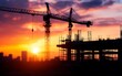© AhmadTriwahyuutomo - A vibrant sunset silhouette of construction cranes over a building site, symbolizing growth and development in urban environments.
