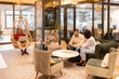 © ADDICTIVE STOCK - People collaborating in a modern creative coworking space