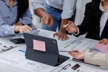 Wall Mural - Group of confident business people point to graphs and charts to analyze market data, balance sheet, account, net profit to plan new sales strategies to increase production capacity.	