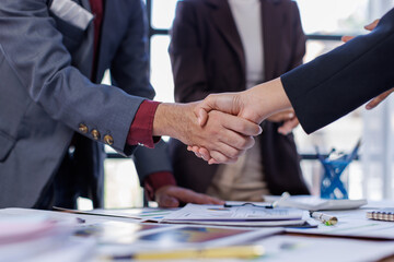 Business handshake for teamwork of business merger and acquisition,successful negotiate,hand shake,two businessman shake hand with partner to celebration partnership and business deal concept
