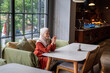 © Hardollin - A thoughtful woman wearing a hijab sits in a cafe reflecting and enjoying the peaceful ambiance.