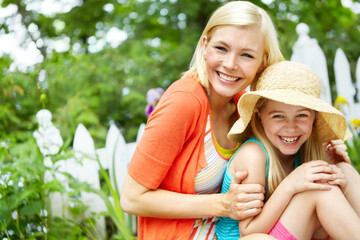 Wall Mural - Portrait, happy mother and child relax in garden for love, care and bonding together. Face, girl and kid with mama outdoor for family connection, relationship and daughter with hat with parent in USA