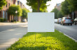 © Oksana - Yard sign mockup in the grass near the walking path on the city street background. Blank yard sign in green grass on sunny day