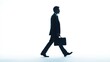 © Prapan - Side view silhouette of a businessman holding a briefcase, walking forward with purposeful strides