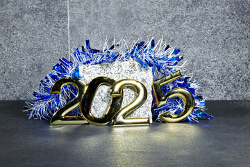 golden  numbers 2025 two thousand twenty five new year with blue tinsel and marble stone