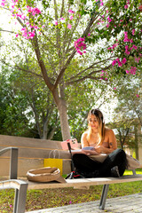 Dynamic Latin businesswoman juggling business calls with two phones