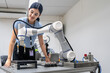 © Nassorn - Hispanic engineer woman working on AI technology in robotics electronics engineering laboratory. University students' research project is programming robot machine with intelligent mechanical control