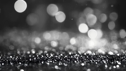 Poster - An elegant black and white background featuring shimmering bokeh lights and glitter, evoking a sophisticated and timeless feel.