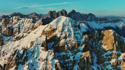 Wall Mural - aerial around view of amazing rocky mountains in snow at sunrise, dolomites, italy, 4k