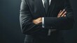 © Hammam - A businessman stands with his arms crossed in a confident and powerful pose.