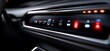 © Ashalina - Closeup of a car's dashboard with glowing buttons and lights.