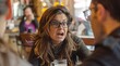 © Ruslan Gilmanshin - Woman wearing glasses with an intense, expressive reaction during a conversation at a cafe, surrounded by people in a lively, casual setting
