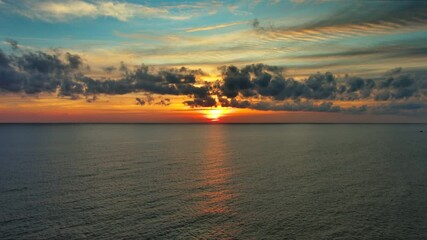 Wall Mural - aerial view of sea surface during a beautiful colourful sunset, 4k