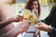 © peopleimages.com - Hands, group and friends with champagne toast for social reunion, holiday success and New Years celebration. People, cheers and alcohol drink with congratulations, gathering fun and party achievement