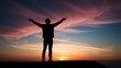 © yogiandrias - Silhouette of a Man with Arms Raised Against a Sunset Sky