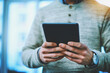 © peopleimages.com - Business, man and hands with tablet at office with research for news, stock market and share prices. Male person, closeup and entrepreneur on internet or website for social media and connection