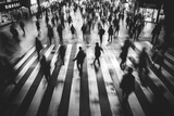 Blurred people crossing the street in black and white