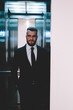 © BullRun - Thoughtful businessman standing and looking away while elevator doors closing