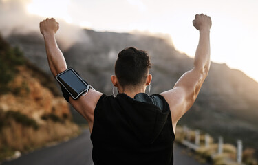 Back, outdoor and man with fitness, cheering and celebration for exercise goals. Nature, healthy runner and athlete with arms raised, training or workout routine with success, achievement or sweating