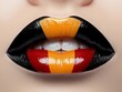 © VISUAL BACKGROUND - A close up of a woman's mouth with a red yellow and black lip
