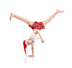 the b-boy in the santa hat is doing a handstand with his feet up