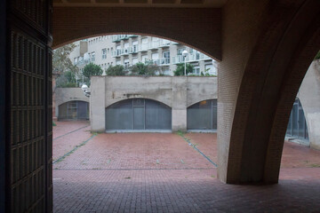 Wall Mural - entrance through an arched passage into the courtyard between the buildings.