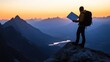 © uu - A person stands on a mountain peak, studying a map against a sunset backdrop.