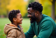 © StockLab - Handsome African American father in his 30s playing and smiling with his young son