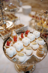 Wall Mural - Sweet cakes with filling on a stand on the buffet table.