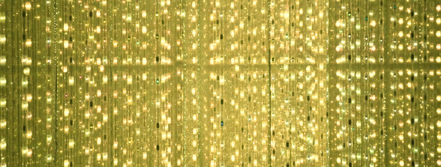 golden background of led flashing, blinking and flickering bulbs.