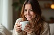 © Vasilii - Smiling woman enjoying a cup of coffee in home background