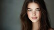 © Blackmint Studio - A young woman with long brown hair and captivating green eyes smiles gently. The soft lighting highlights her features, creating a serene atmosphere that emphasizes her natural beauty