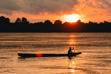 Wall Mural - beautiful landscape sunset, stunning view of the river and lake with orange and blue hues sky, trees