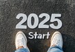 © Emqan - Person Standing on Asphalt with '2025 Start' Text in Gray