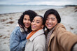 © Davor - Three young women friends taking a selfie on a windy beach