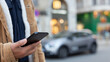 © jorge - Man using smartphone app for electric car rental service in city