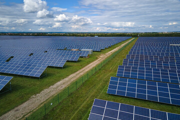 aerial view of large sustainable electrical power plant with rows of solar photovoltaic panels for p