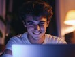 © Alexander Chaykin - Young Man Smiling at Camera, Working on Laptop