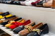 © JackF - Collection of stylish colorful suede and leather womens loafers for sale on shelf in shoe store