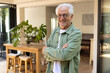 © Wavebreak Media - Smiling senior man standing confidently in cozy living room at home