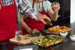 © Wavebreak Media - Senior couple preparing festive meal, pouring olive oil on fresh vegetables, at home