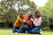 © Wavebreak Media - mutliracial family laughing together outdoors, enjoying playful moment on green grass