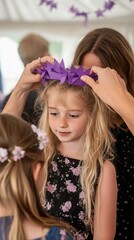 Canvas Print - A young girl is getting a purple crown placed on her head by a woman. AI.