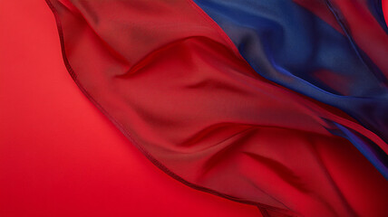 Poster - Colorful silk fabric flowing gracefully against a vibrant red background in soft lighting